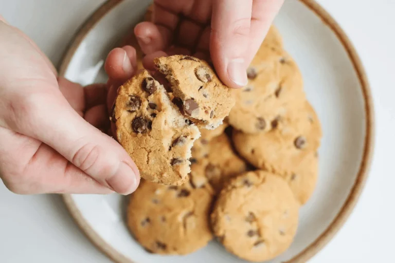 Close-up of freshly baked Oreo Chocolate Chip Cookies stacked in a bowl, showing gooey chocolate chips and crunchy Oreo cookie pieces.